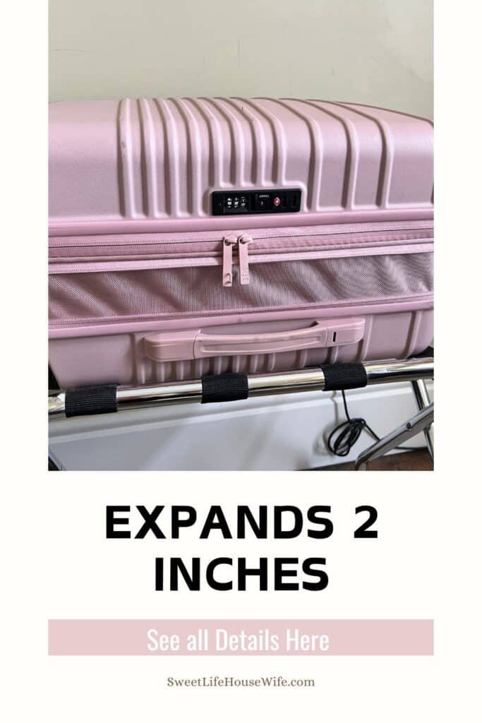 Pink suitcase with a ribbed design, zippered expansion, and built-in lock on a luggage rack. Text reads "EXPANDS 2 INCHES". Calm and functional tone.