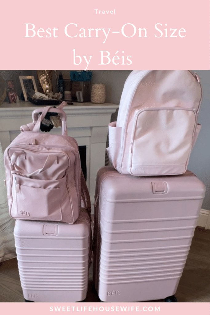 Array of pink Béis luggage, including suitcases and backpacks, arranged in a cozy room. Elegant, practical travel gear displayed on a wooden floor.