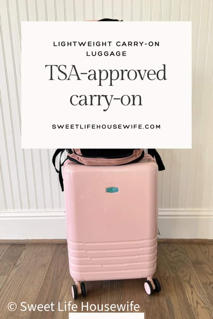 French Pink hard-shell carry-on luggage with wheels, set against a wooden floor and white paneled wall. Text overlay reads "TSA-approved carry-on." For a BagSmart luggage review blog post.