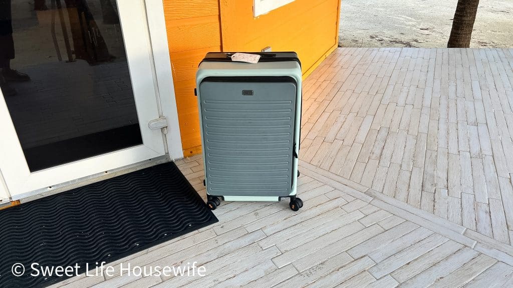 Orange Cabana with 2 tone Level8 hard shell luggage by the door.