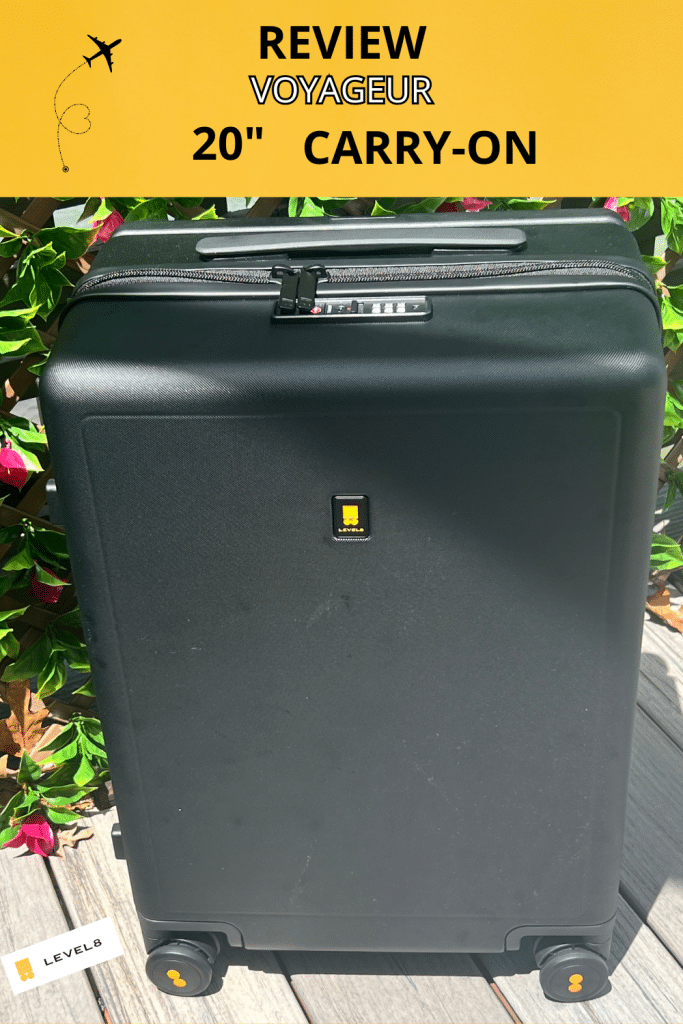 Text overlay reads Review Voyageur 20" Carry-On, and shows a floral wall with a black suitcase by Level8